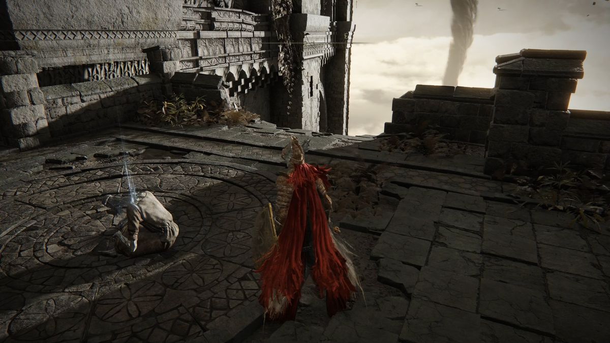 A red-cloaked Elden Ring character stands in front of a body.