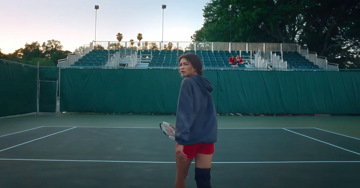 Zendaya walks away from the camera on a tennis court in Challengers