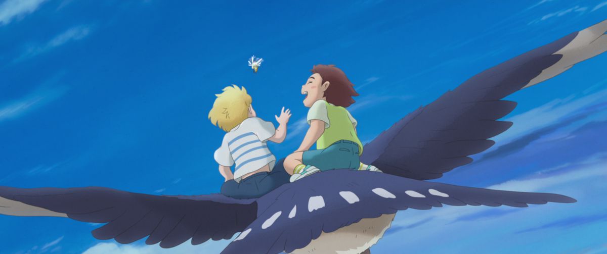 Amanda and her imaginary friend Rudger, a young boy her age, laugh as they ride together on a gigantic red-breasted swallow in Studio Ponoc’s anime movie The Imaginary