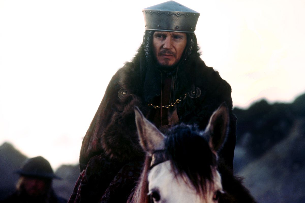 Liam Neeson riding a horse and wearing a metal helmet in Kingdom of Heaven