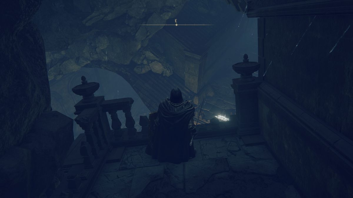 A Tarnished warrior stands on a ledge looking down at the Moorth Ruins underground area in a screenshot from Elden Ring: Shadow of the Erdtree