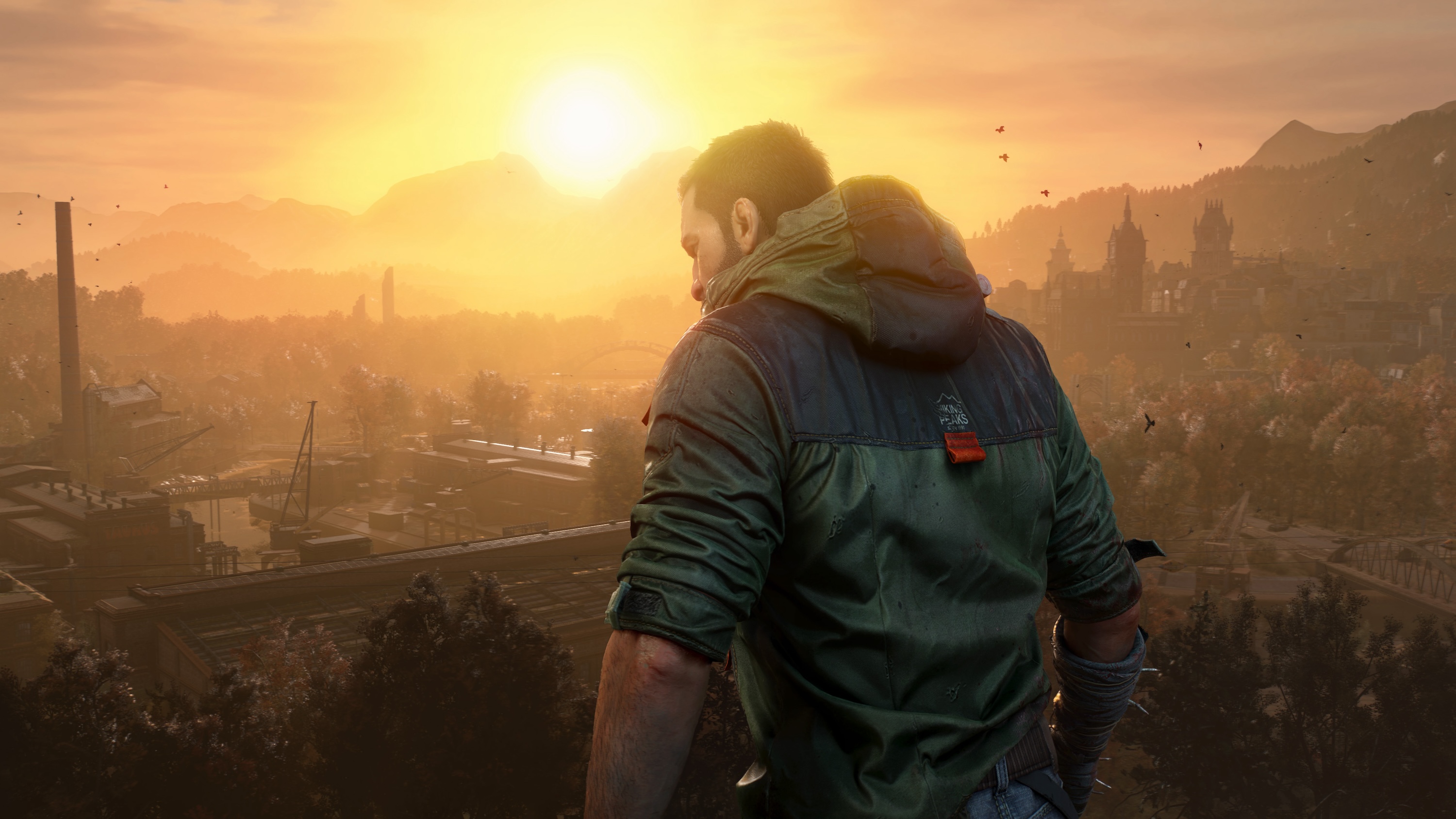 A Dying Light: The Beast screenshot shows main character Kyle Crane standing in front of a sunset with a video of a city in the background.