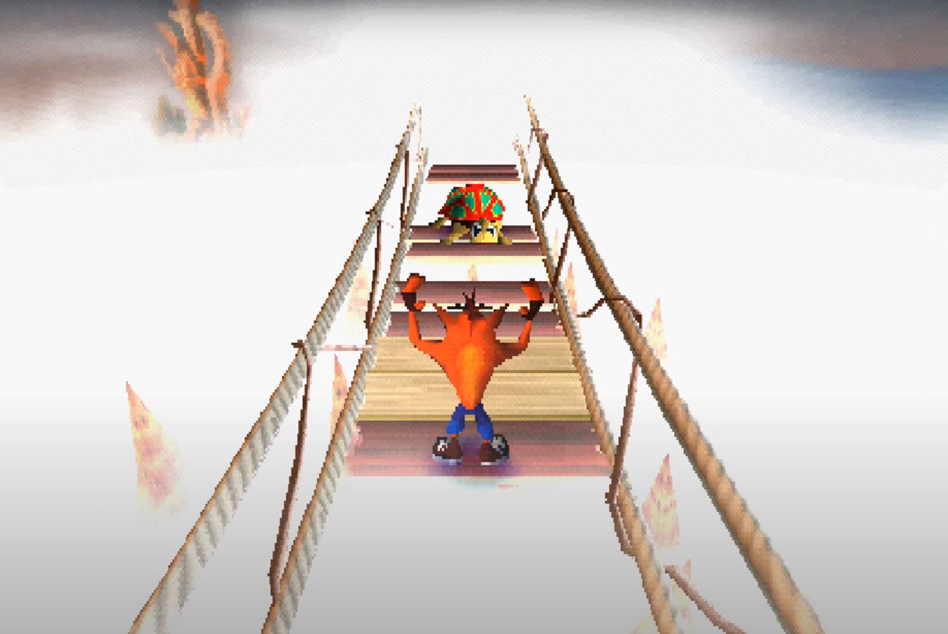 Crash Bandicoot stands on a wooden slat bridge that’s so high up it’s surrounded by cloud cover. He raises his hands in the air, preparing to jump on a turtle on the bridge in front of him