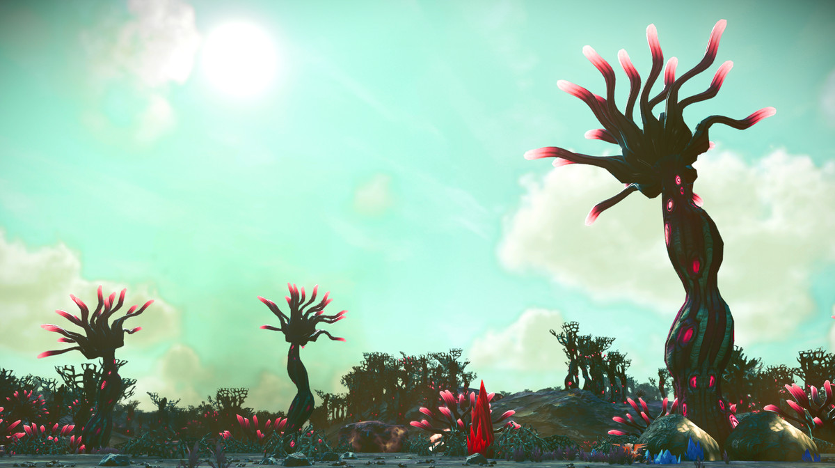 Three plants on a planet in No Man’s Sky, with spindly flora topped with pink bulbs, against a light cyan sky.