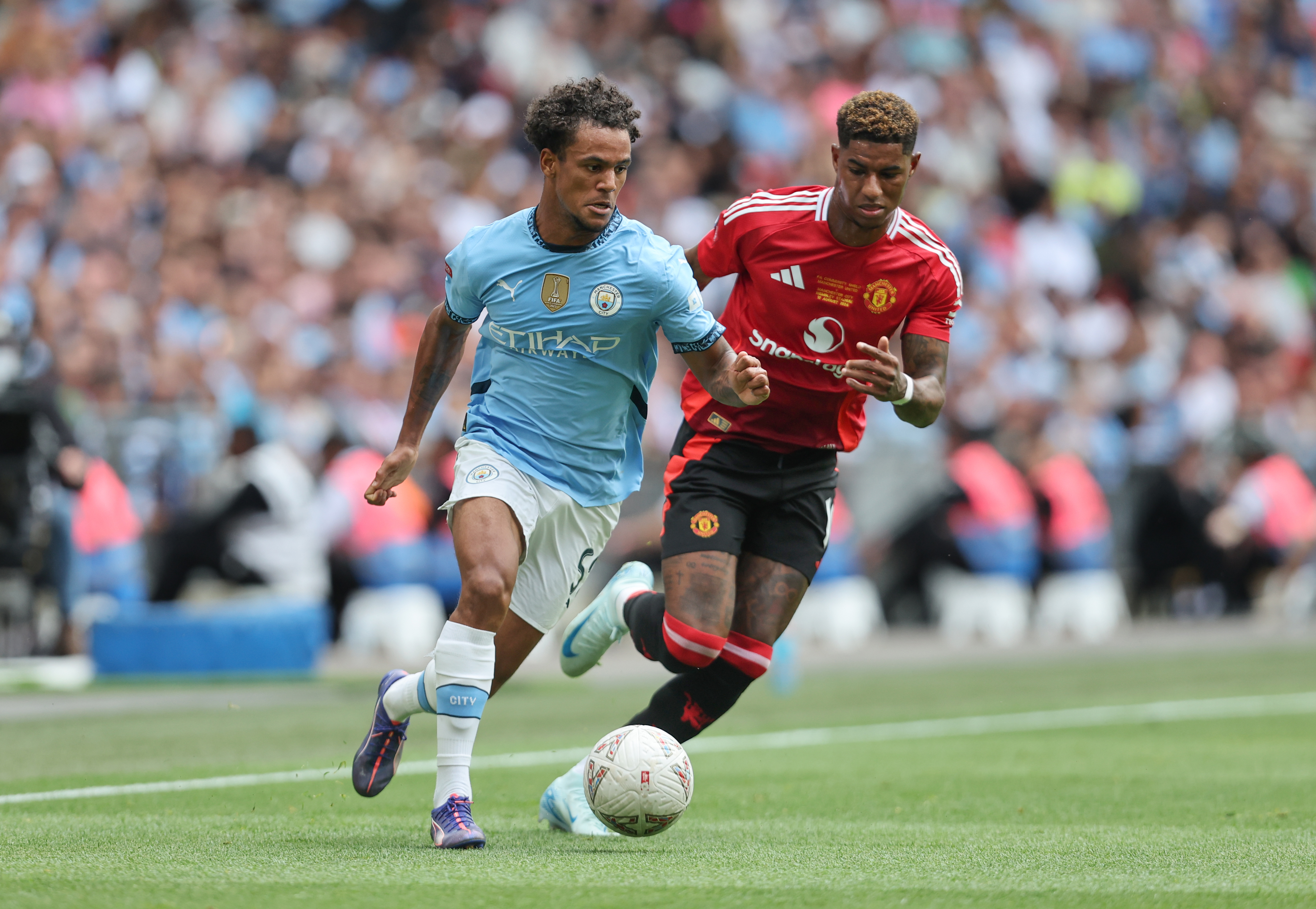 LONDON, ENGLAND - AUGUST 10: Manchester City’s Oscar Bobb and Manchester United’s Marcus Rashford during the 2024 FA Community Shield match between Manchester United and Manchester City at Wembley Stadium on August 10, 2024 in London, England. (Photo by Rob Newell - CameraSport via Getty Images)