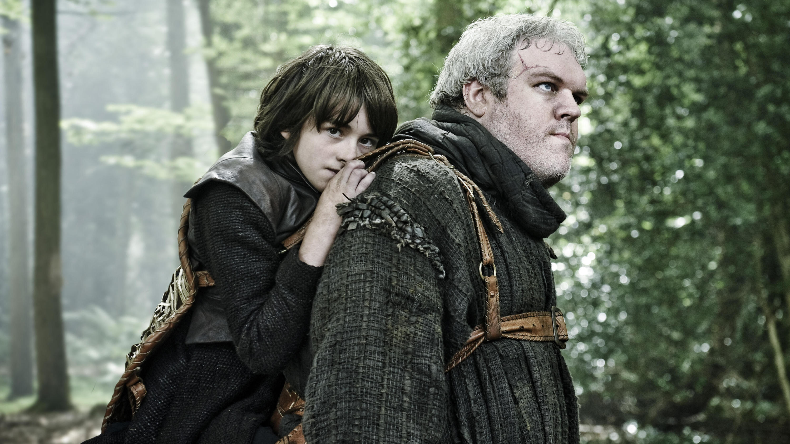 In a scene from season 1 of Game of Thrones, Hodor (Kristian Nairn) carries young Bran (Isaac Hempstead Wright) in a harness on his back after Bran loses the use of his legs