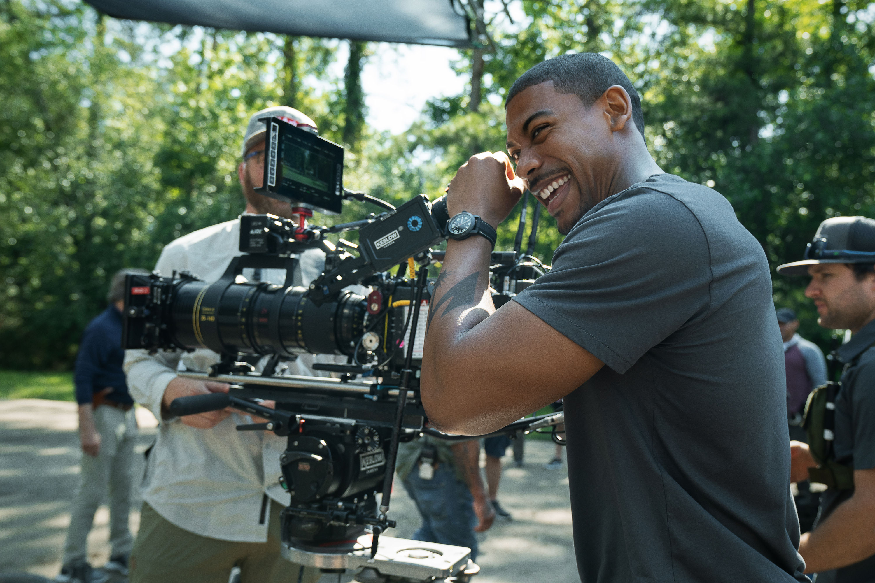 Star Aaron Pierre laughs as he cups the eyepiece of one of the cameras on the set of Jeremy Saulnier’s Netflix movie Rebel Ridge