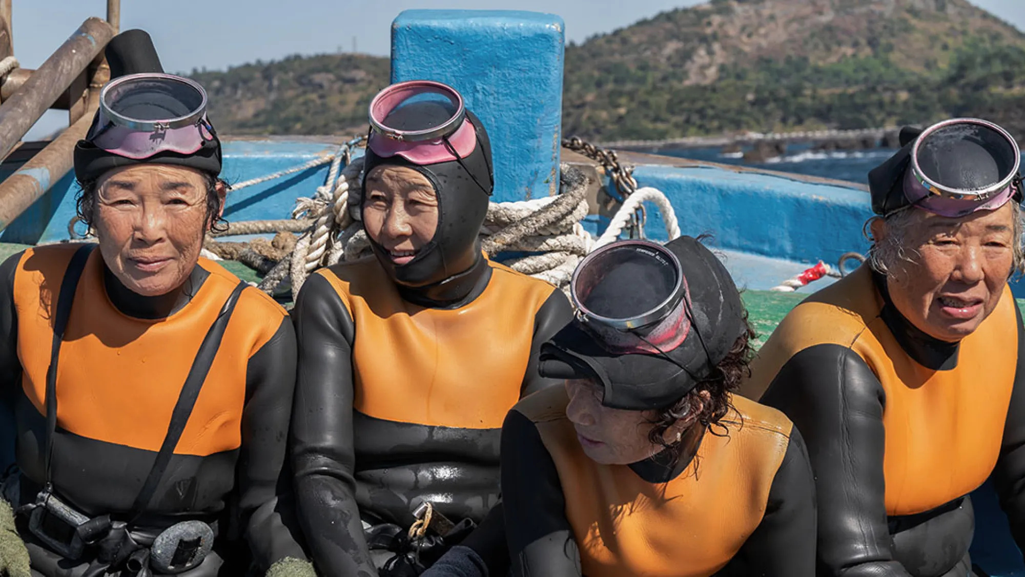 Four women in scuba suits in The Last of the Sea Women.