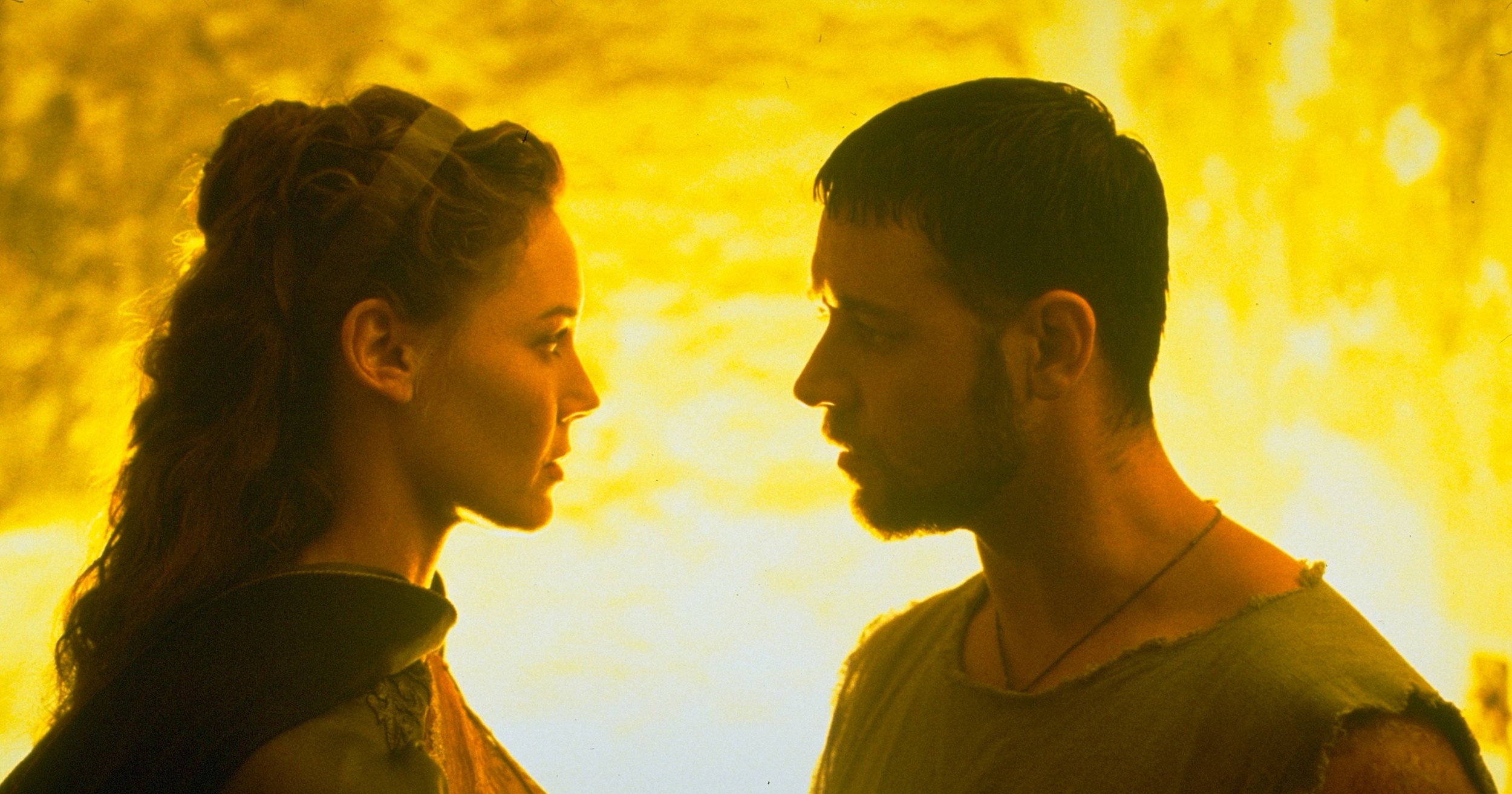 The emperor’s daugher Lucilla (Connie Nielsen) faces gladiator Maximus (Russell Crowe) in a closeup backlit with fiery yellow light in 2000’s Gladiator