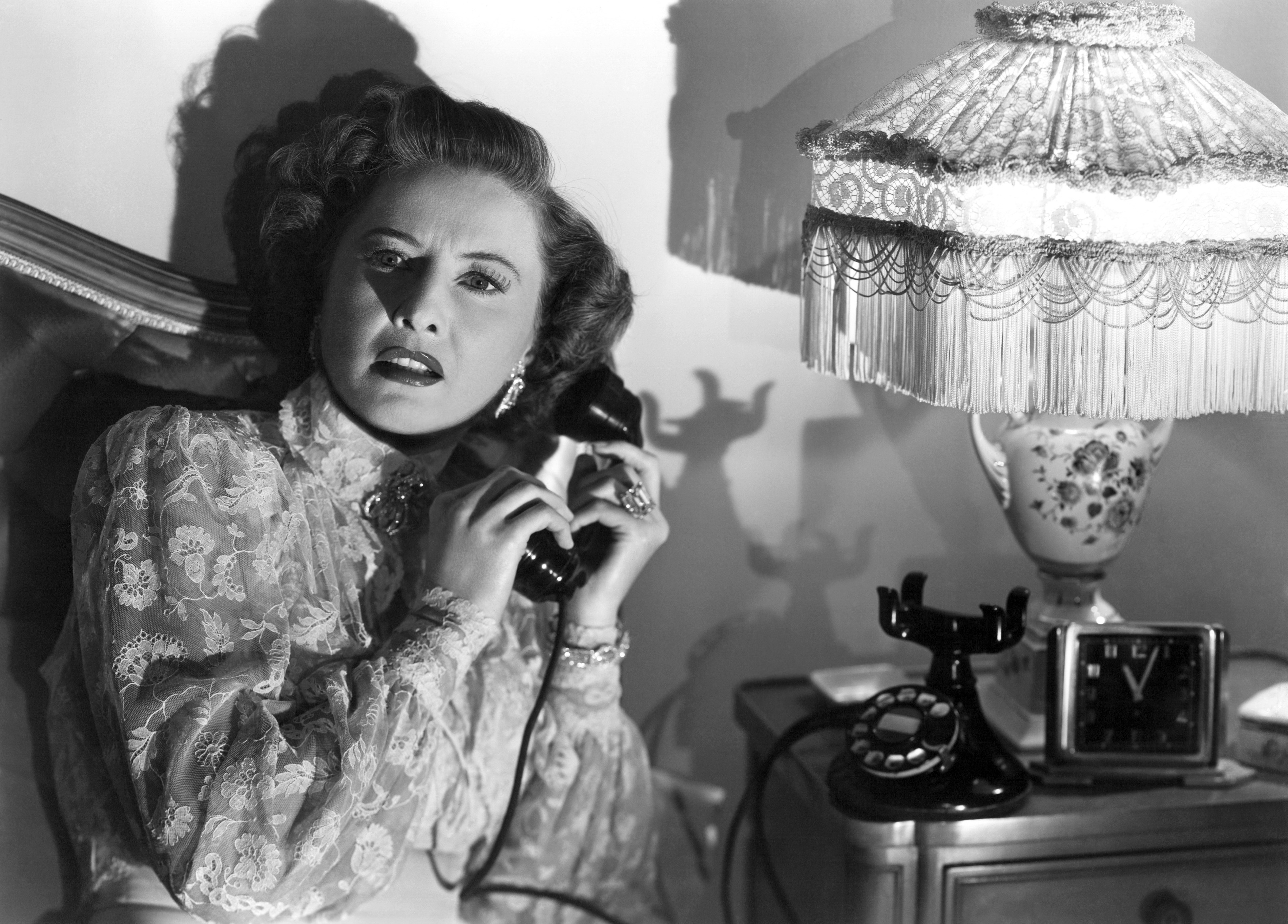 Barbara Stanwyck looks shocked with a phone to her ear in Sorry, Wrong Number