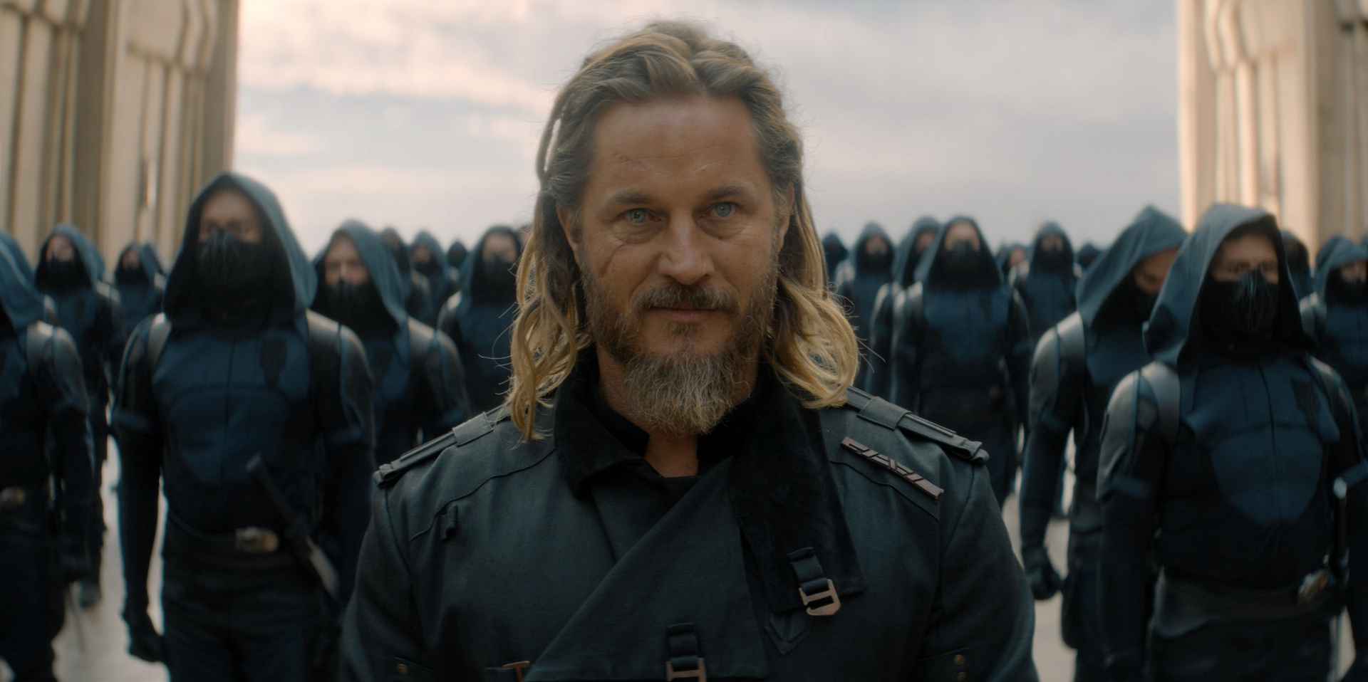 Desmond Hart (Travis Fimmel) standing in front of the emperor’s army looking satisfied in a still from Dune: Prophecy