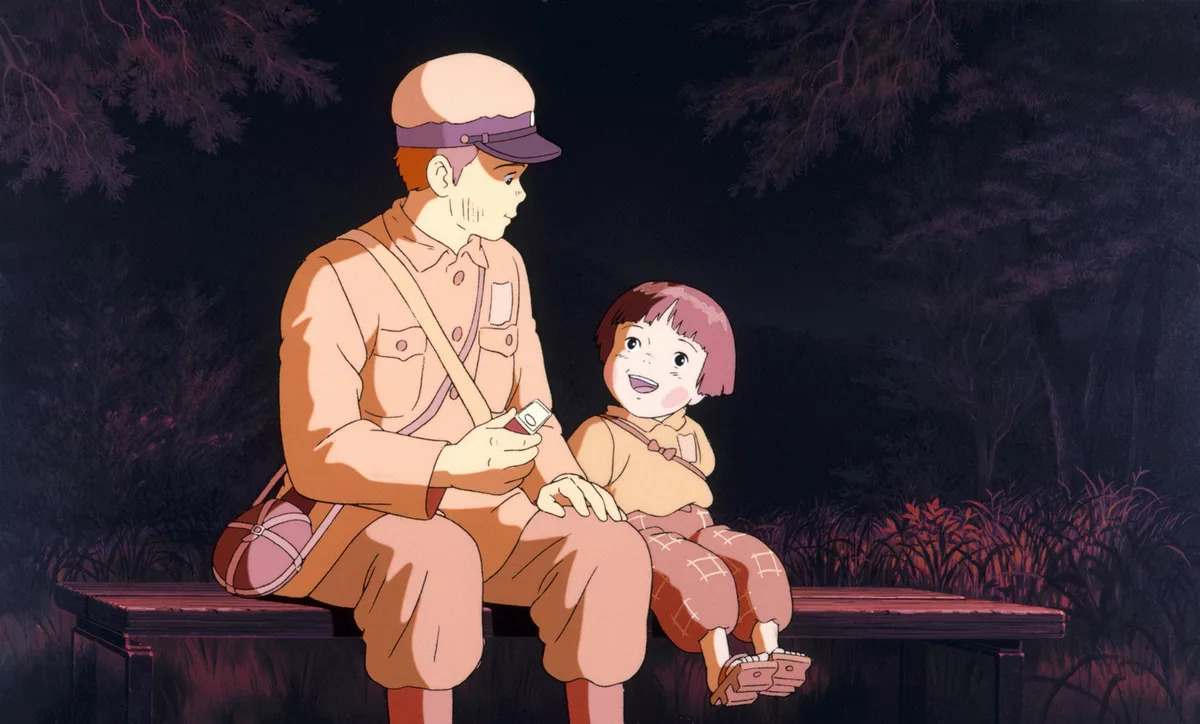 An anime teenager sitting on a bench next to a smiling anime girl in Grave of the Fireflies.