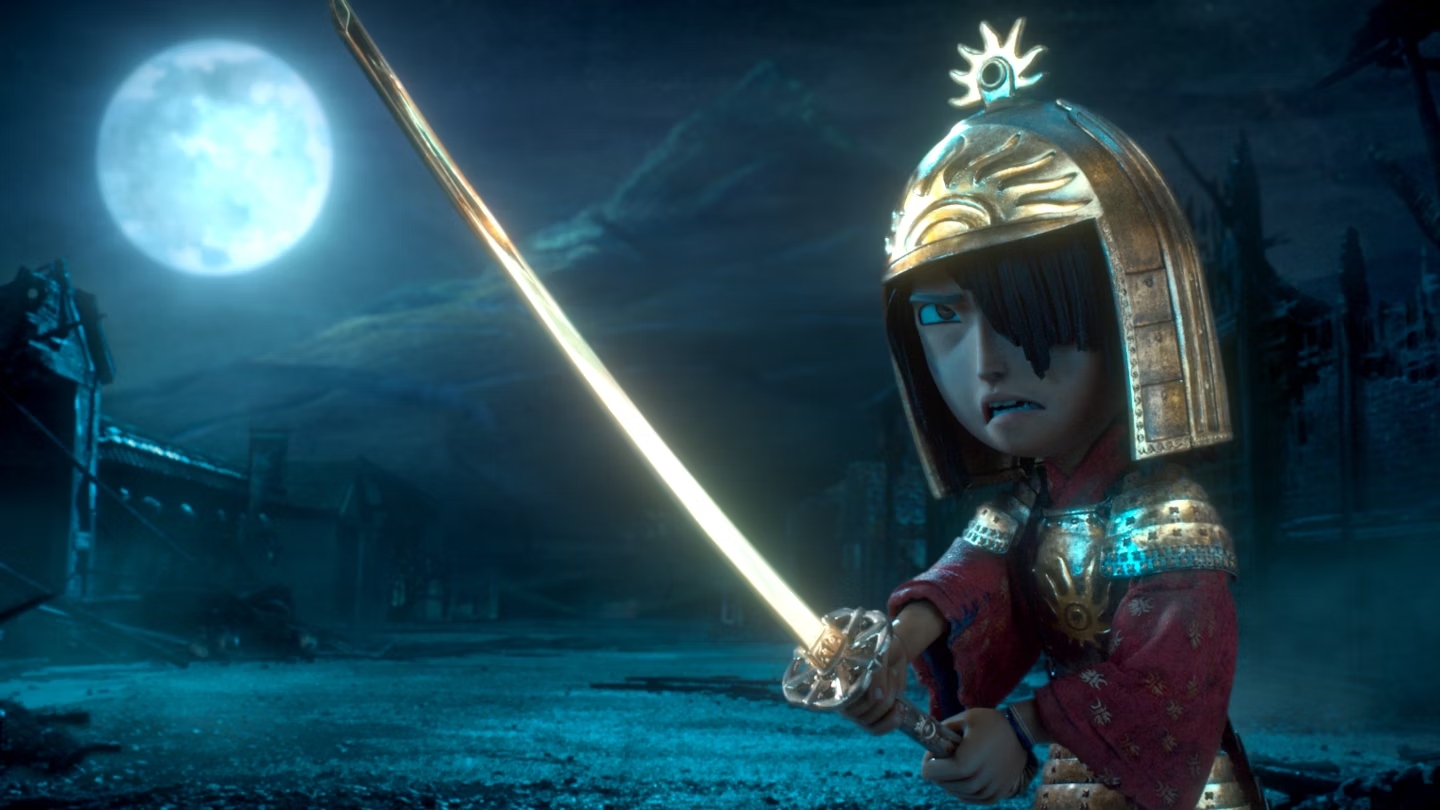 A boy wearing a golden helmet wielding a golden katana in a barren field lit by a large moon in Kubo and the Two Strings.