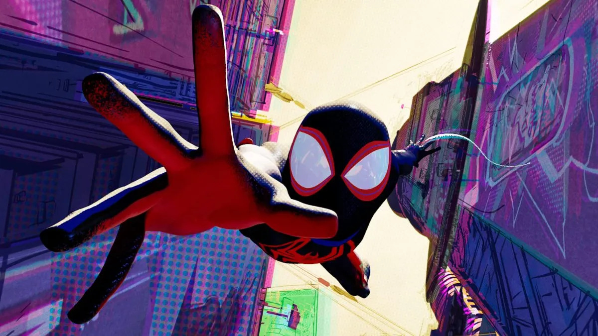 A close-up shot of Miles Morales in his black Spider-Man suit falling through a cityscape in Spider-Man: Across the Spider-Verse.