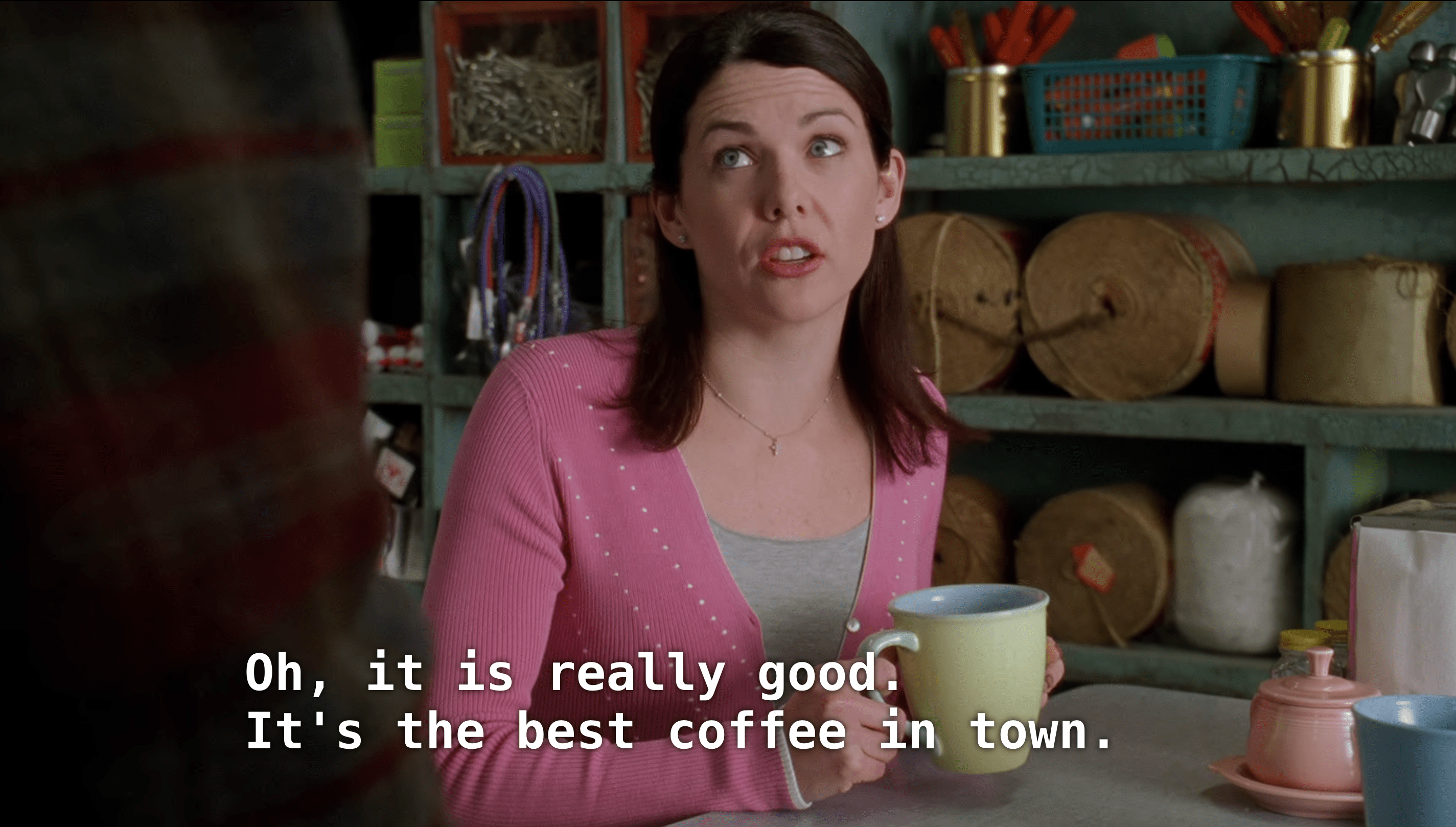 Lorelei Gilmore telling someone “Oh it is really good. It’s the best coffee in town.” in a still from Gilmore Girls’ pilot episode