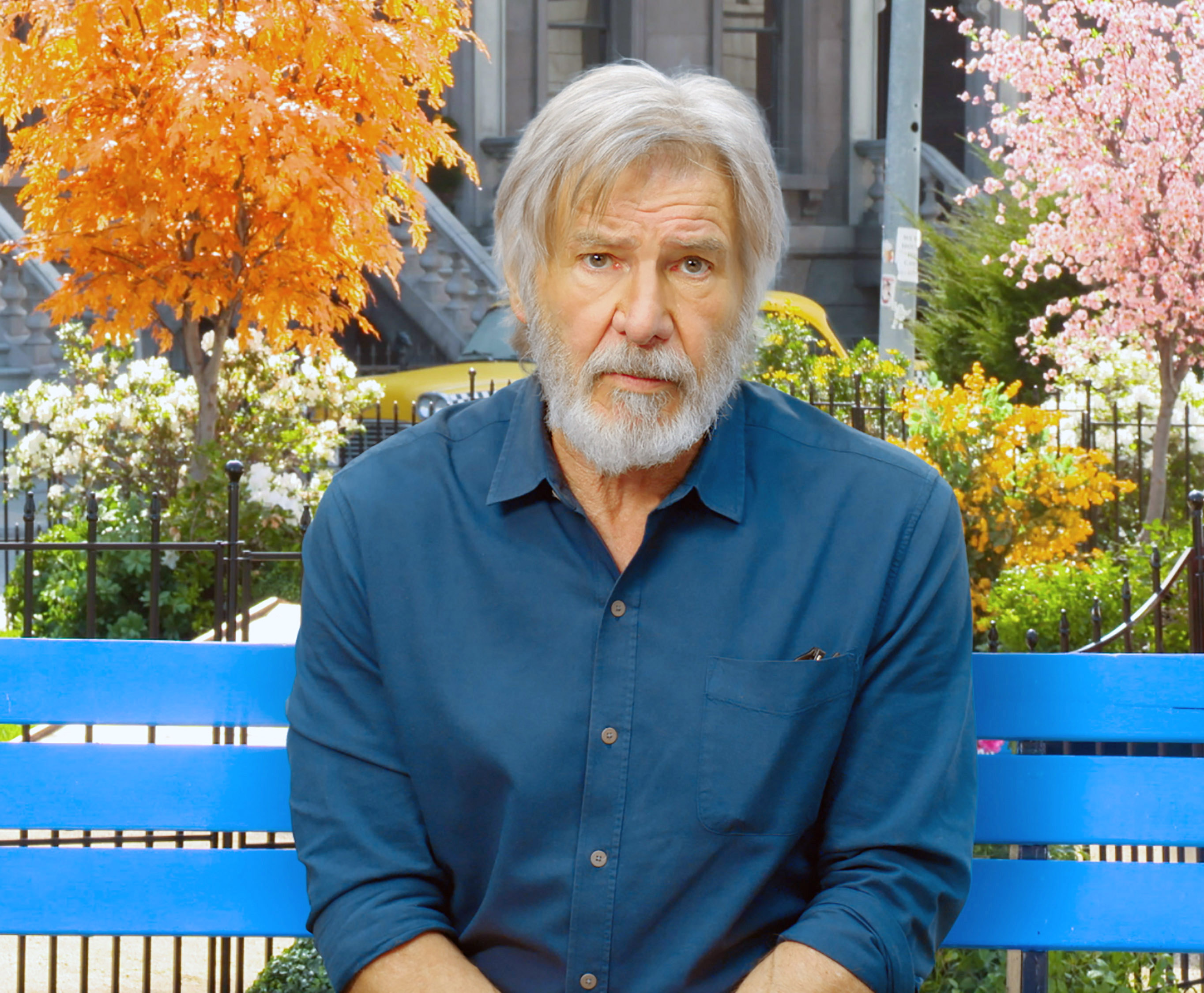 Harrison Ford scowling on a bench during press for Secret Life of Pets 2