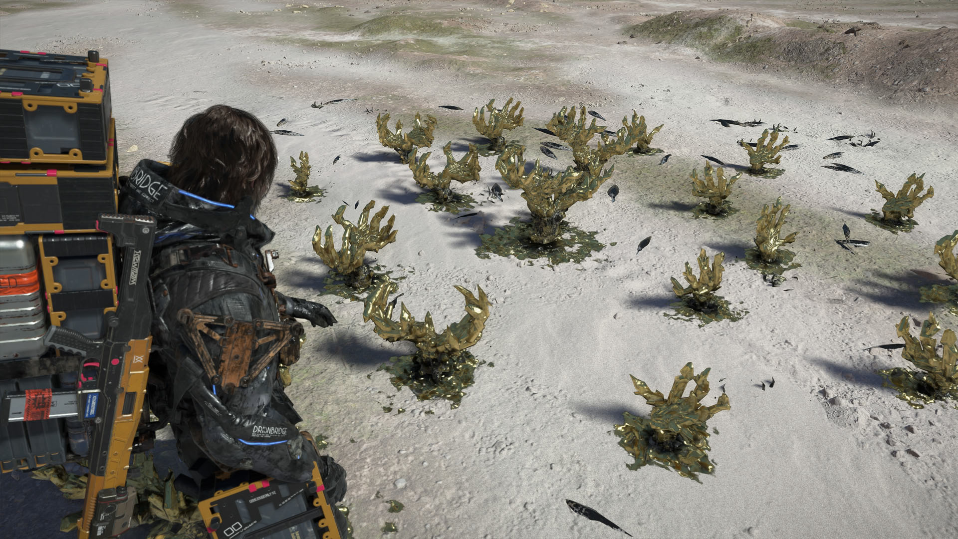 A Death Stranding 2 screenshot showing the character looking at golden crystals that look like claws.