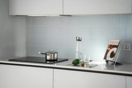 Why Zelda Cookbook Sales Are Outpacing Traditional Gaming Guides Open cookbook on kitchen counter with cooking ingredients and utensils around it