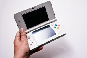 Close-up view of a handheld gaming device with screen and controls visible