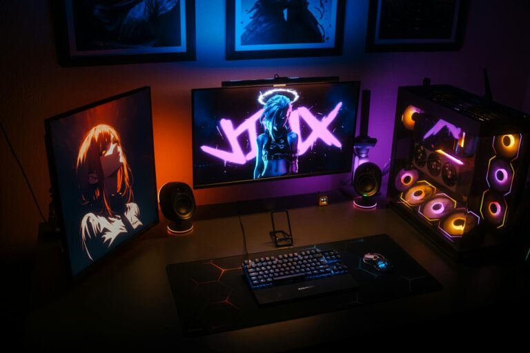 Modern gaming setup with multiple monitors and streaming equipment on desk