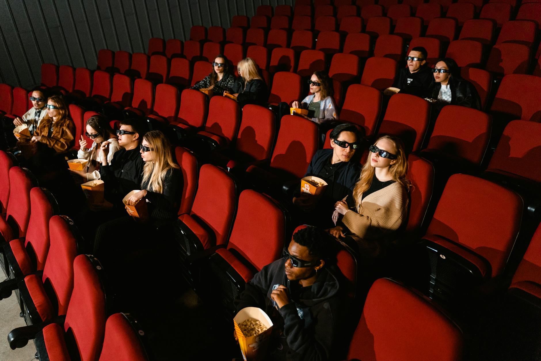 Movie theater interior with rows of seats facing large screen