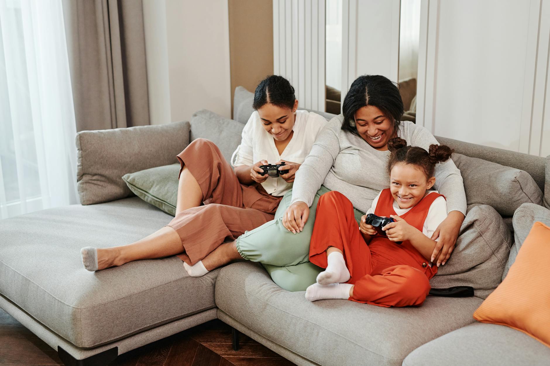 Family members playing video games together in living room