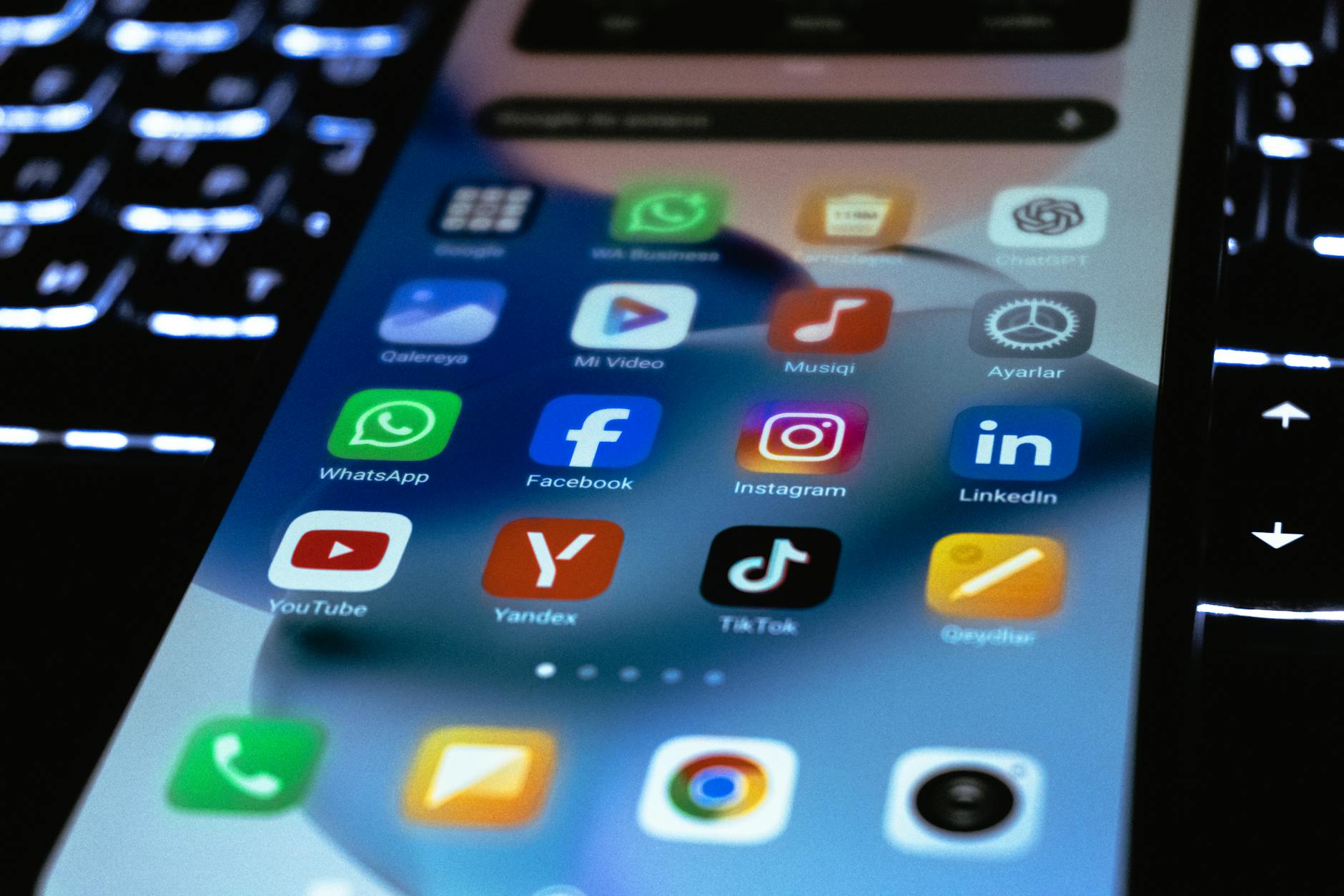 Person using smartphone with social media icons and notifications visible