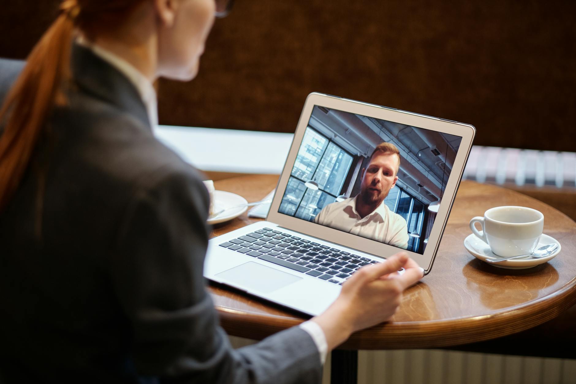 Remote team meeting displayed on computer screen showing multiple participants in video call