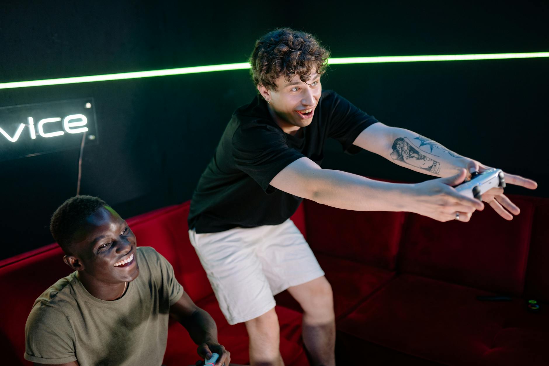 Gaming controller on table next to television displaying console video game menu