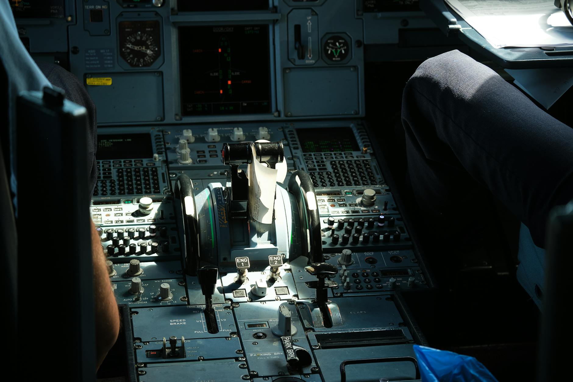 Real aircraft cockpit interior showing complex instrument panels and flight controls