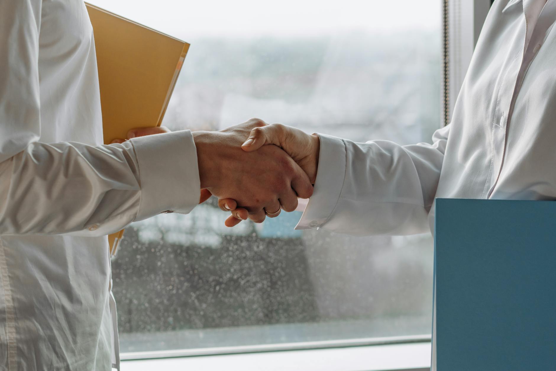 Professional handshake representing partnership agreement between companies