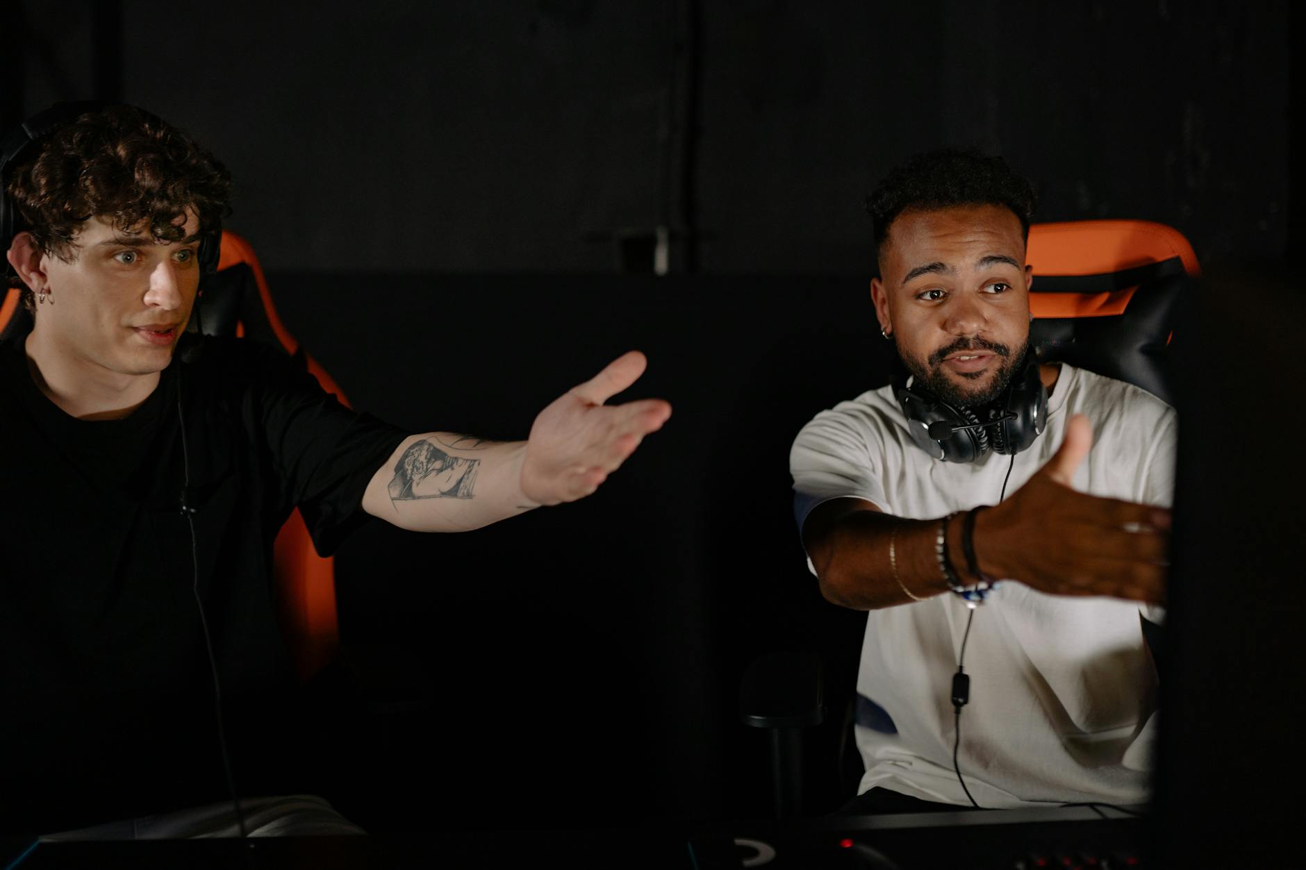 Person engaging with online gaming community through computer screen showing forums and chat