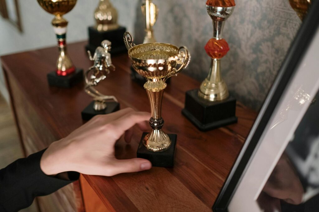 A shiny gaming award trophy displayed on a shelf, symbolizing game of the year recognition
