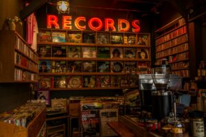 Rows of vinyl records in a music store, representing physical music sales and soundtrack releases