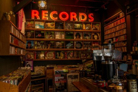 Rows of vinyl records in a music store, representing physical music sales and soundtrack releases