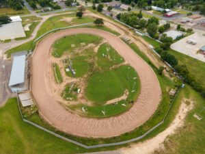 Aerial view of a colorful racing track representing Mario Kart World course design