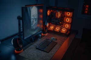 Modern gaming PC setup with RGB lighting and multiple monitors displaying video games