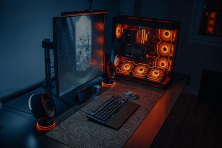Sony’s PC Ports Are Arriving Day-One Alongside Console Releases Modern gaming PC setup with RGB lighting and multiple monitors displaying video games