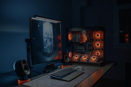 Modern gaming computer setup with multiple monitors displaying game interfaces
