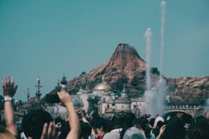 Large crowds of visitors waiting in lines at a busy theme park attraction
