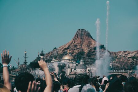 Large crowds of visitors waiting in lines at a busy theme park attraction