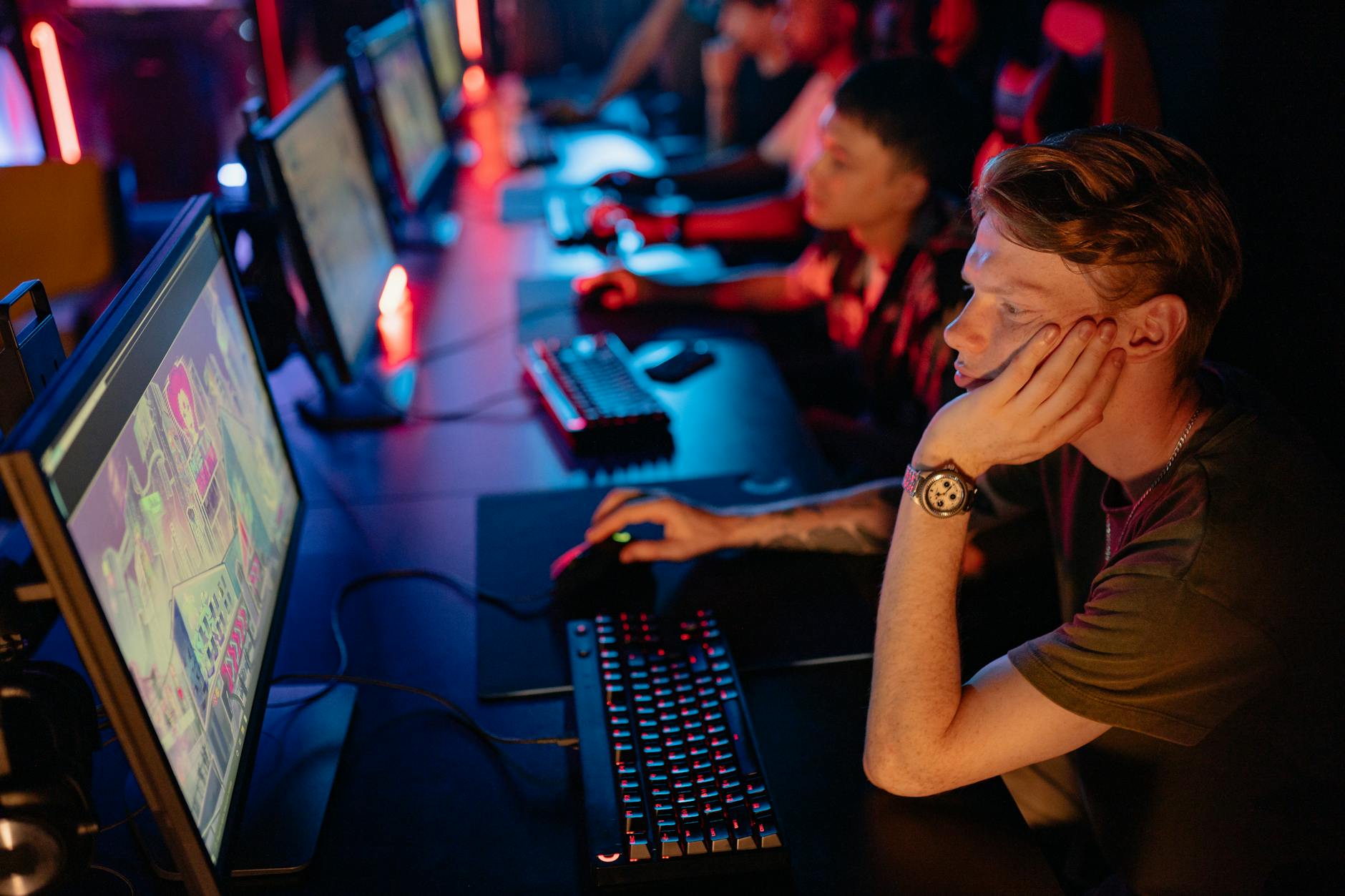 Professional esports tournament with multiple gaming stations and competitive players