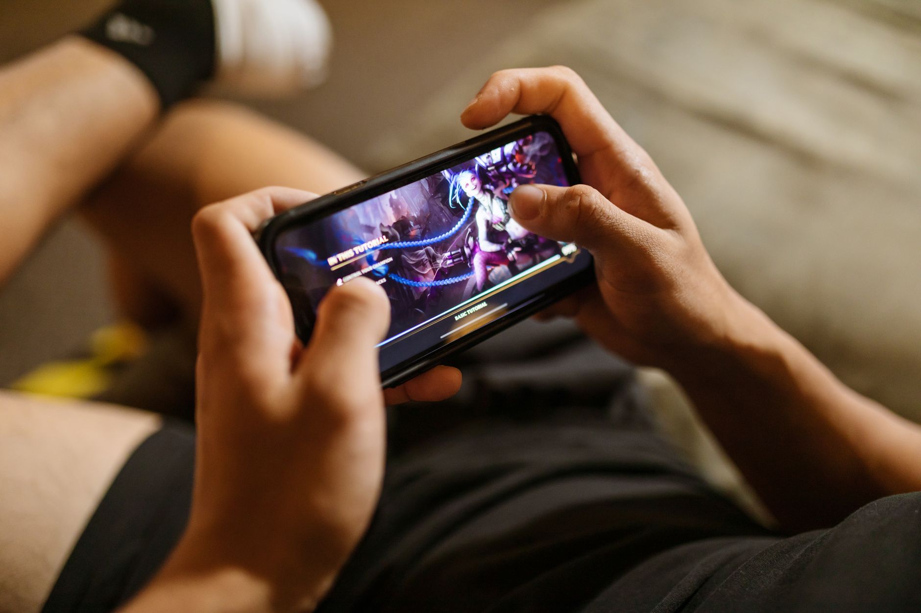 Person holding a smartphone playing a mobile card collecting game