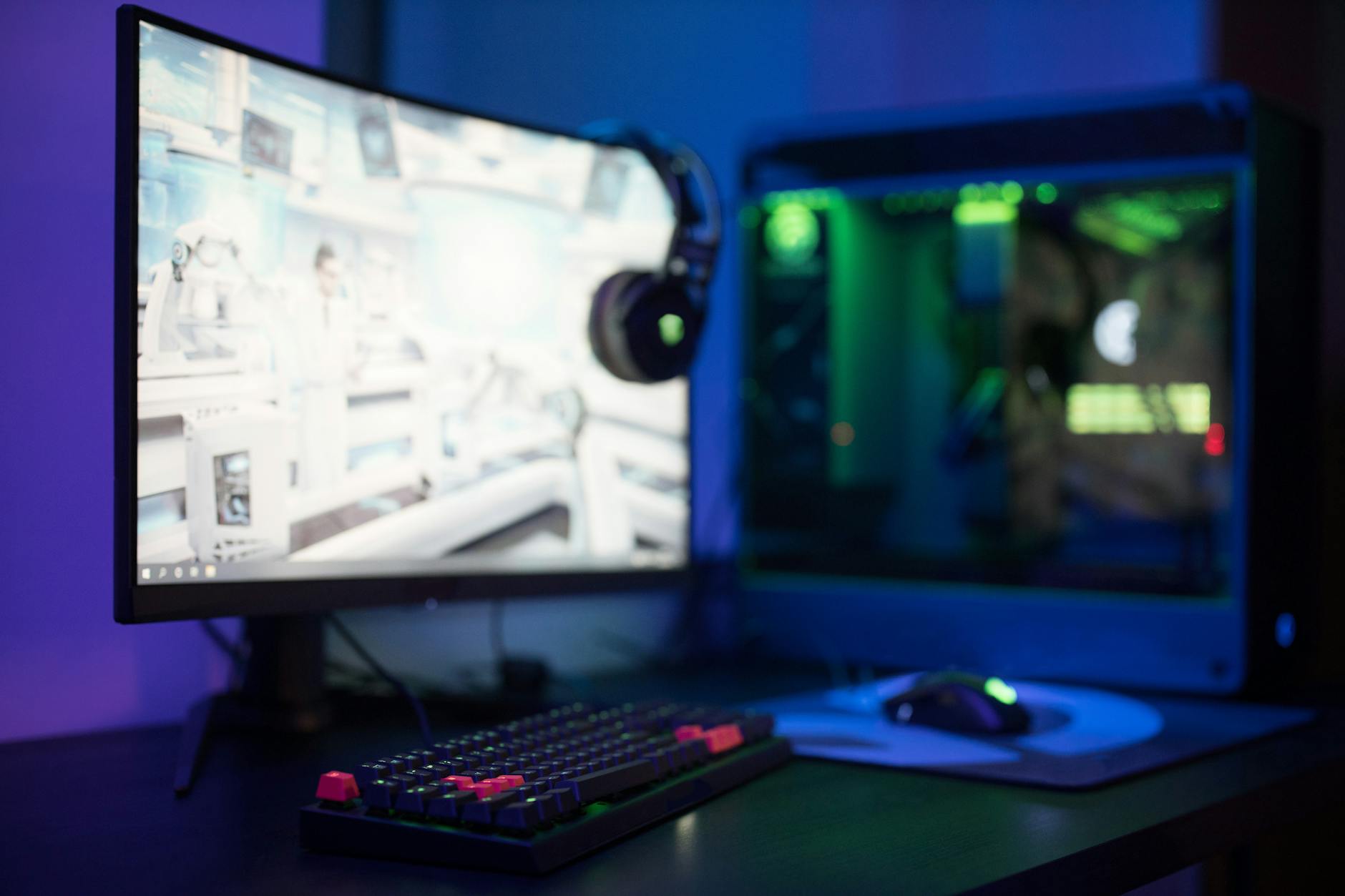 Gaming setup with multiple monitors showing gameplay footage and timer overlays