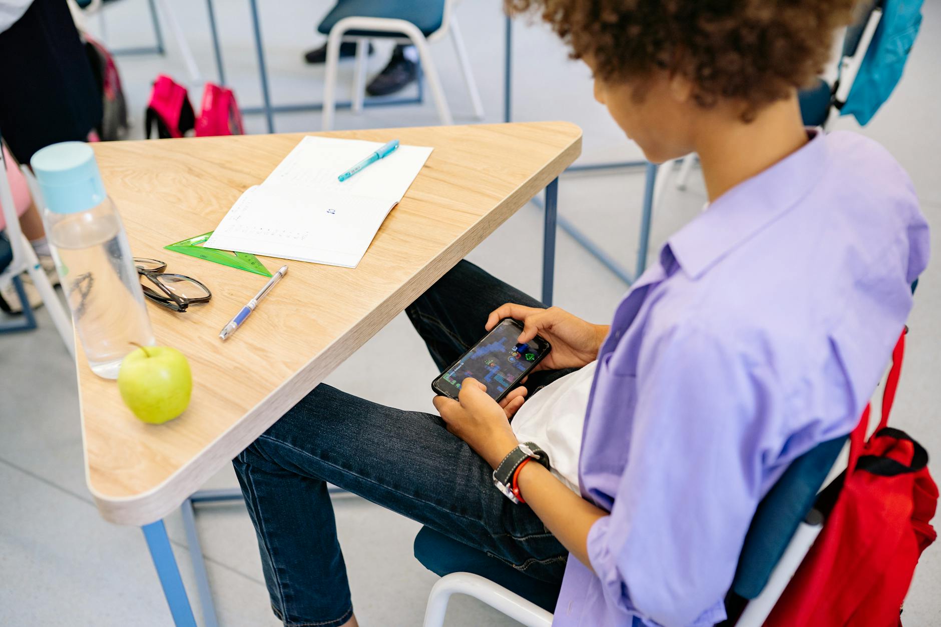 Person playing a mobile game on a smartphone outdoors