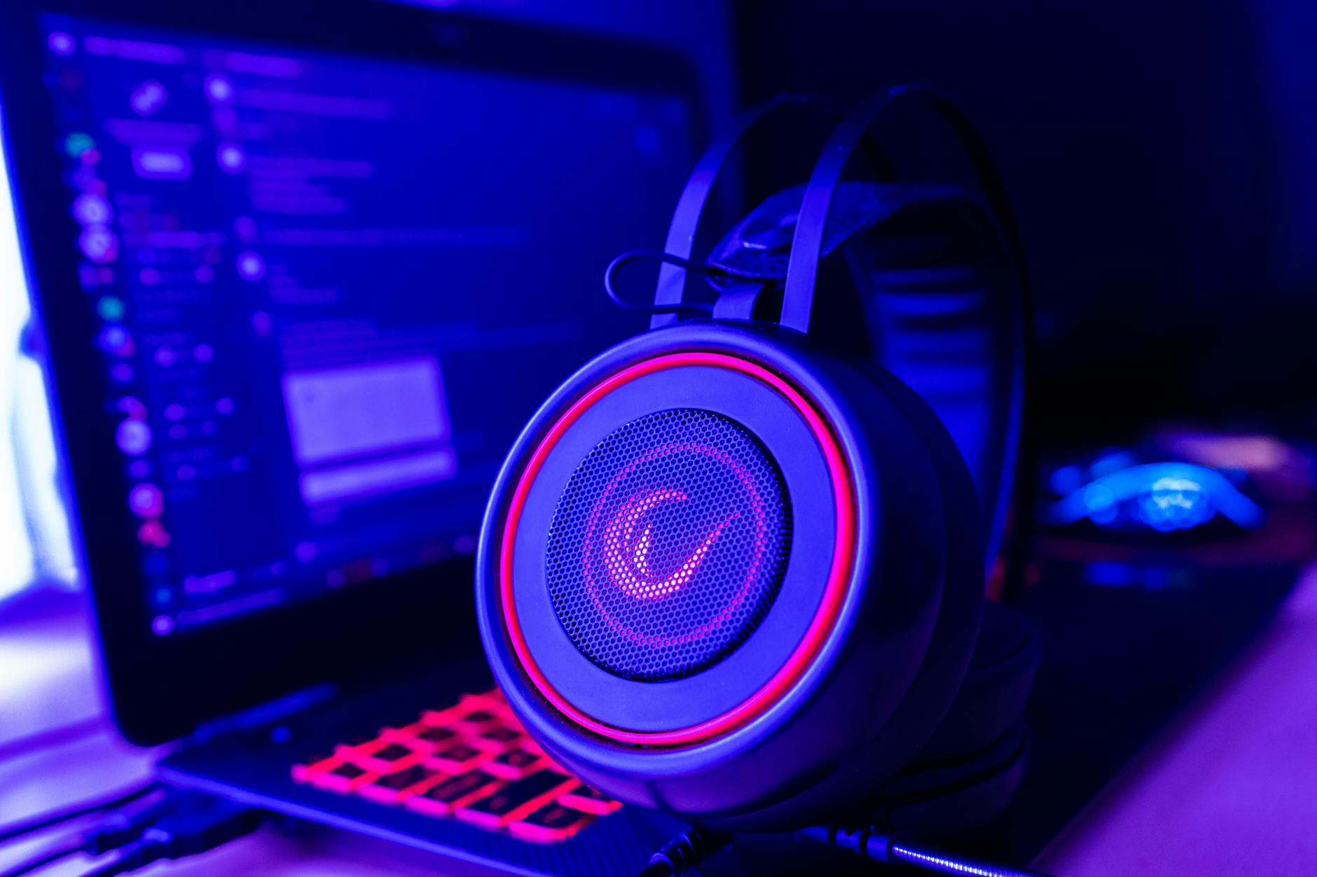 Gaming setup with headphones and illuminated keyboard