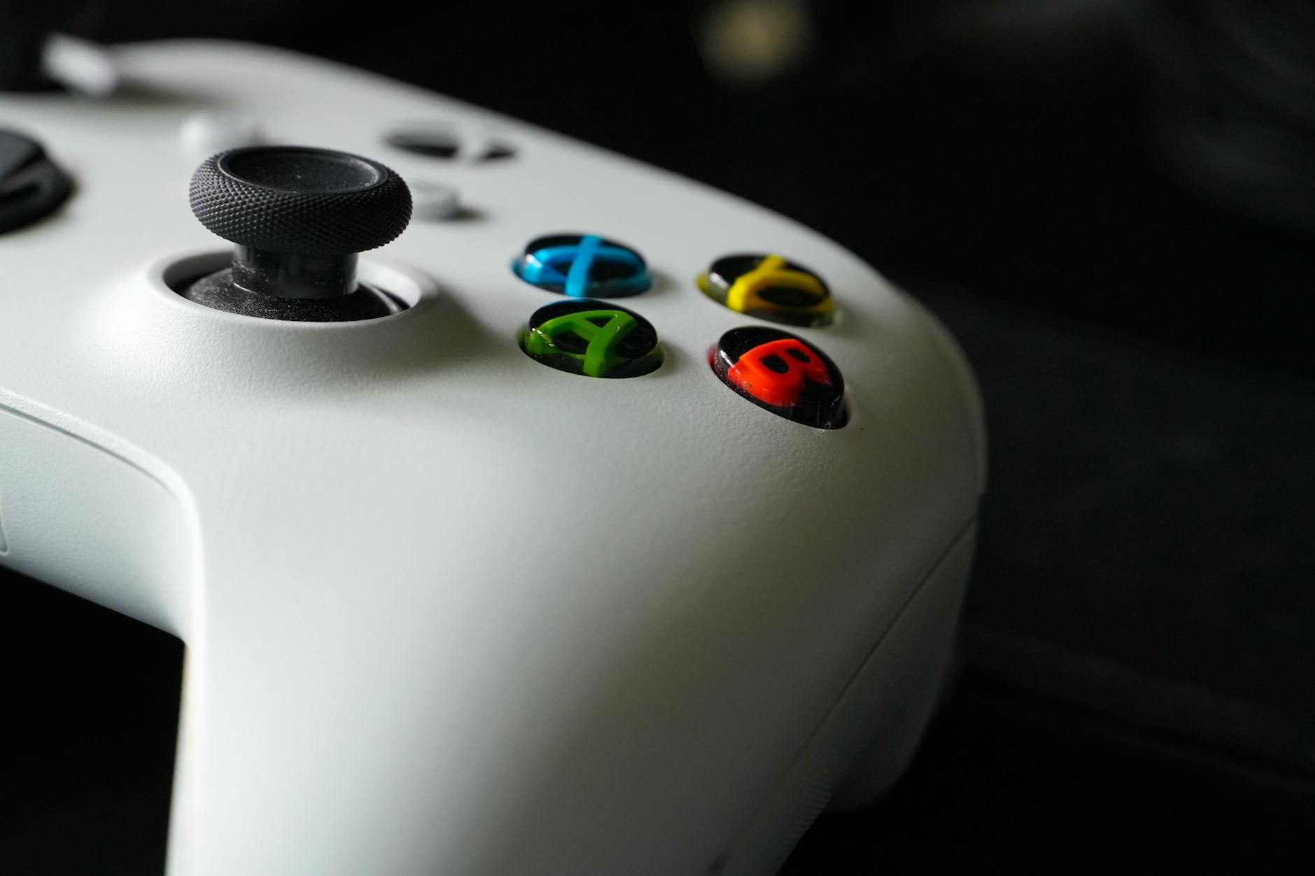 Close-up view of a video game controller showing buttons and analog sticks