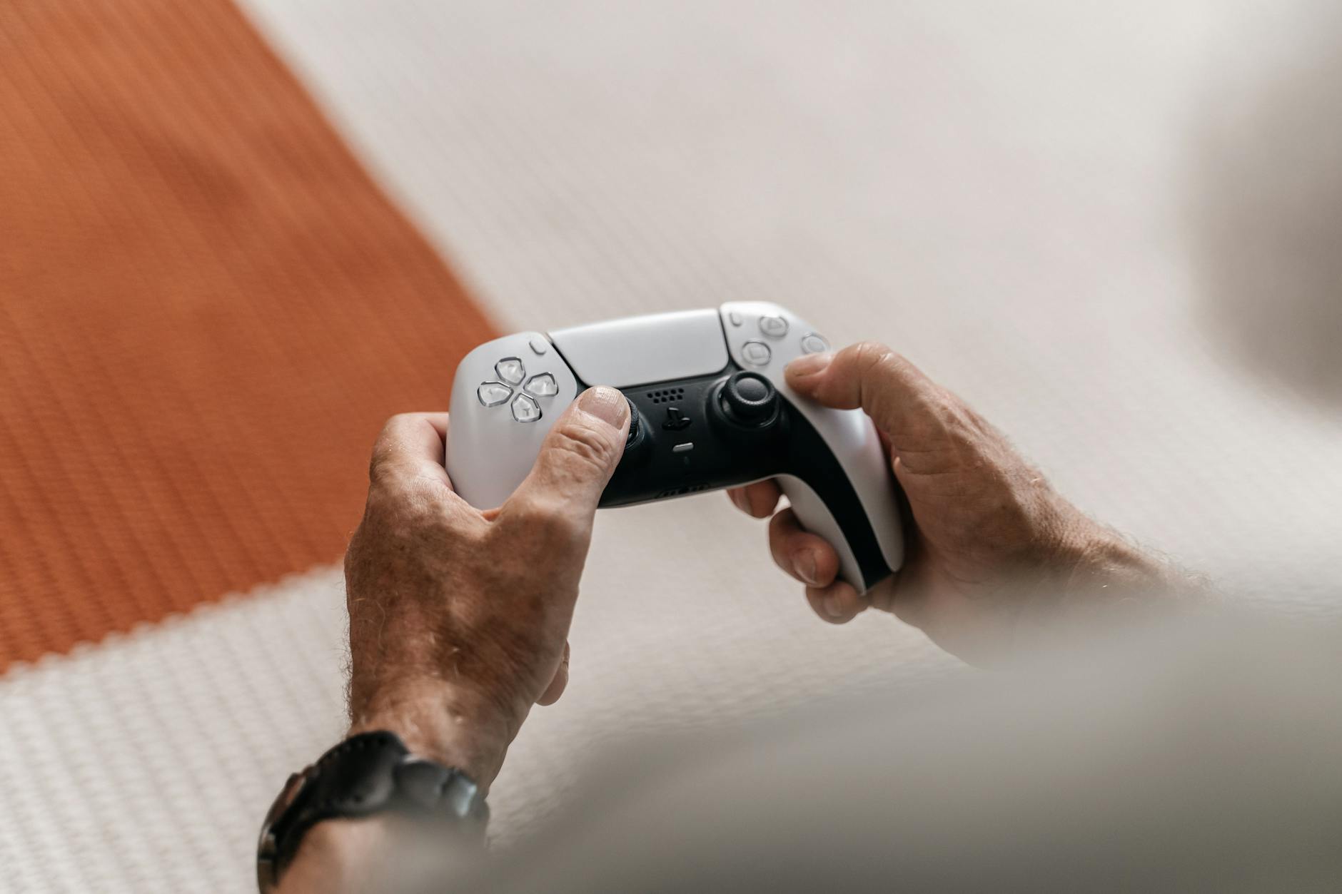 Close-up of hands holding a gaming controller, representing interactive entertainment