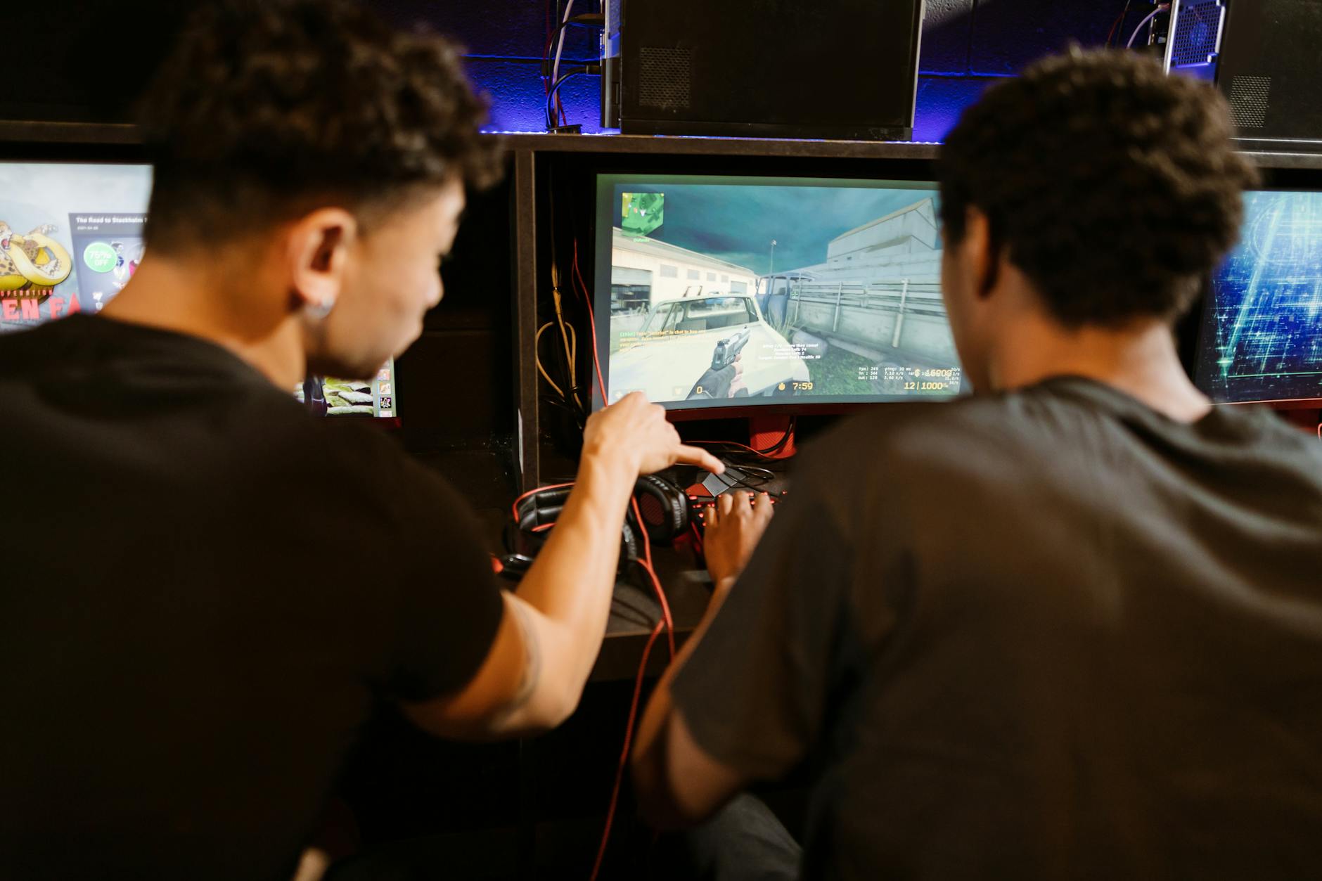 A person playing a video game on a large screen in a darkened room