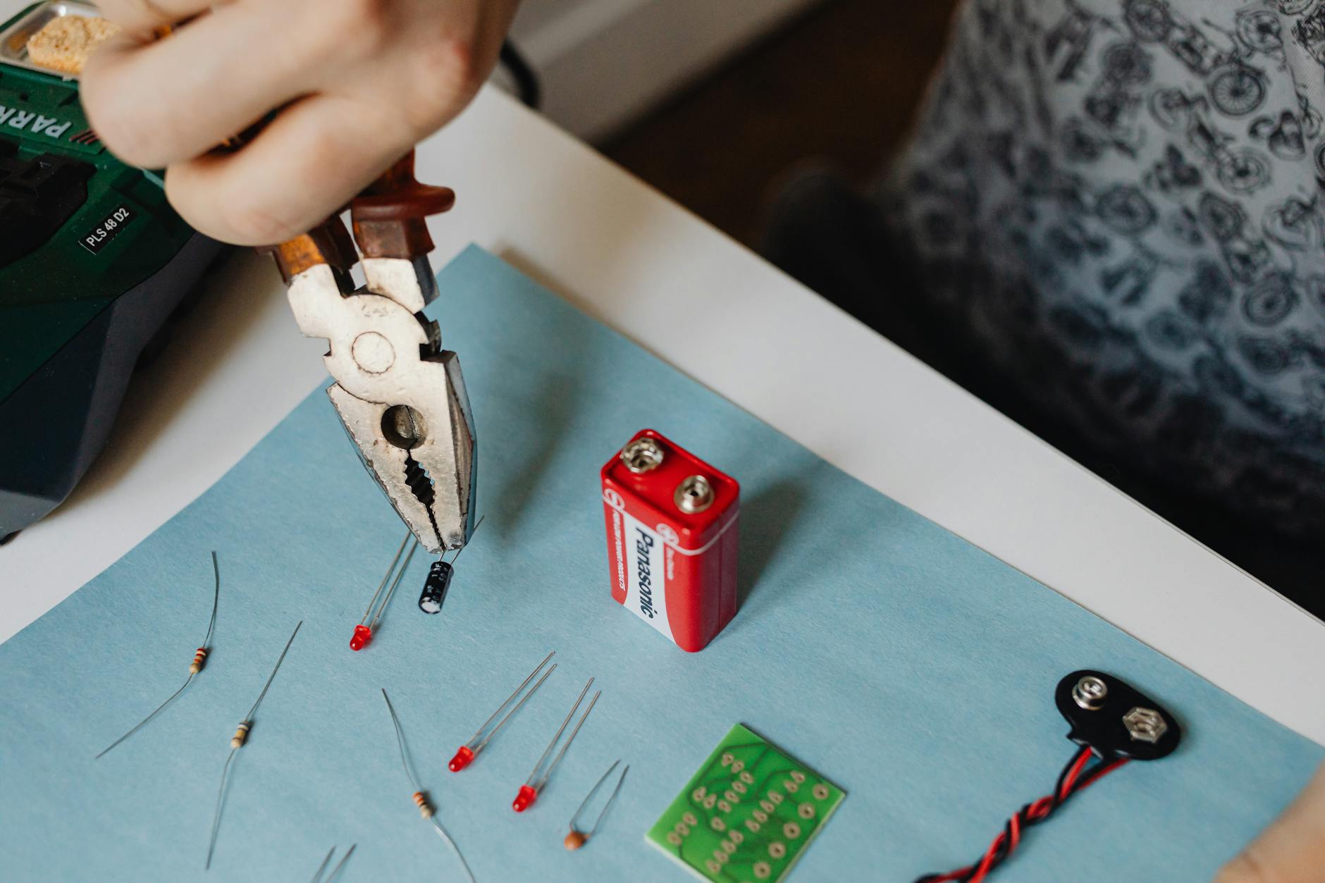 Small electronics repair tools and components laid out on a work surface